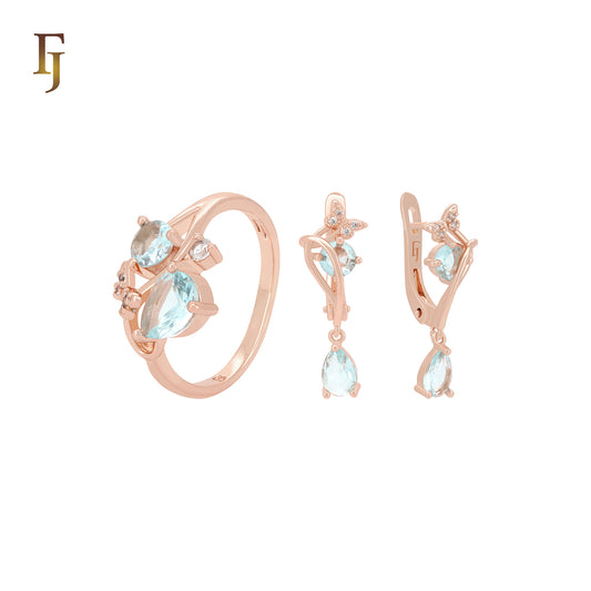 Conjunto de joyas de dos tonos con anillos en oro rosa y circonitas blancas en racimo de mariposas azules y blancas.