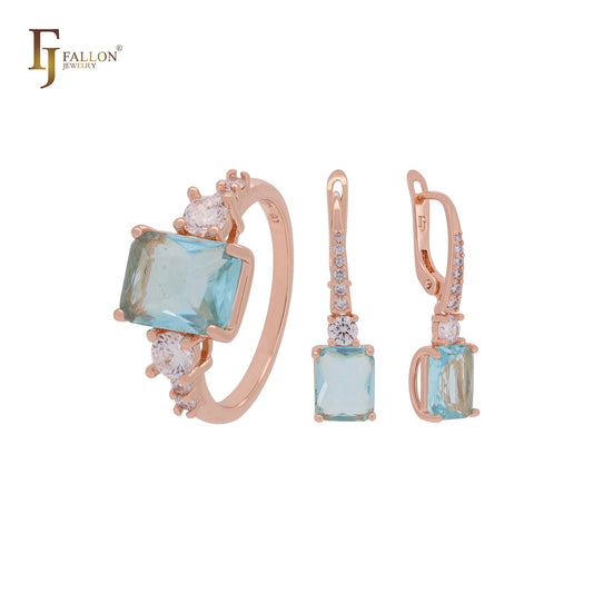 Conjunto de joyas de oro rosa con solitario de talla esmeralda, circonitas blancas y azul lago, y anillos.