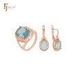 Conjunto de joyas con anillos en oro rosa y circonitas cúbicas en azul lago con halo de filigrana de ondas abundantes