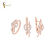 Conjunto de joyas de oro rosa de dos tonos con anillos y círculo de circonitas blancas entrelazadas.