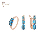 Conjunto de joyas de oro rosa con triple racimo de circonitas azul océano y anillos